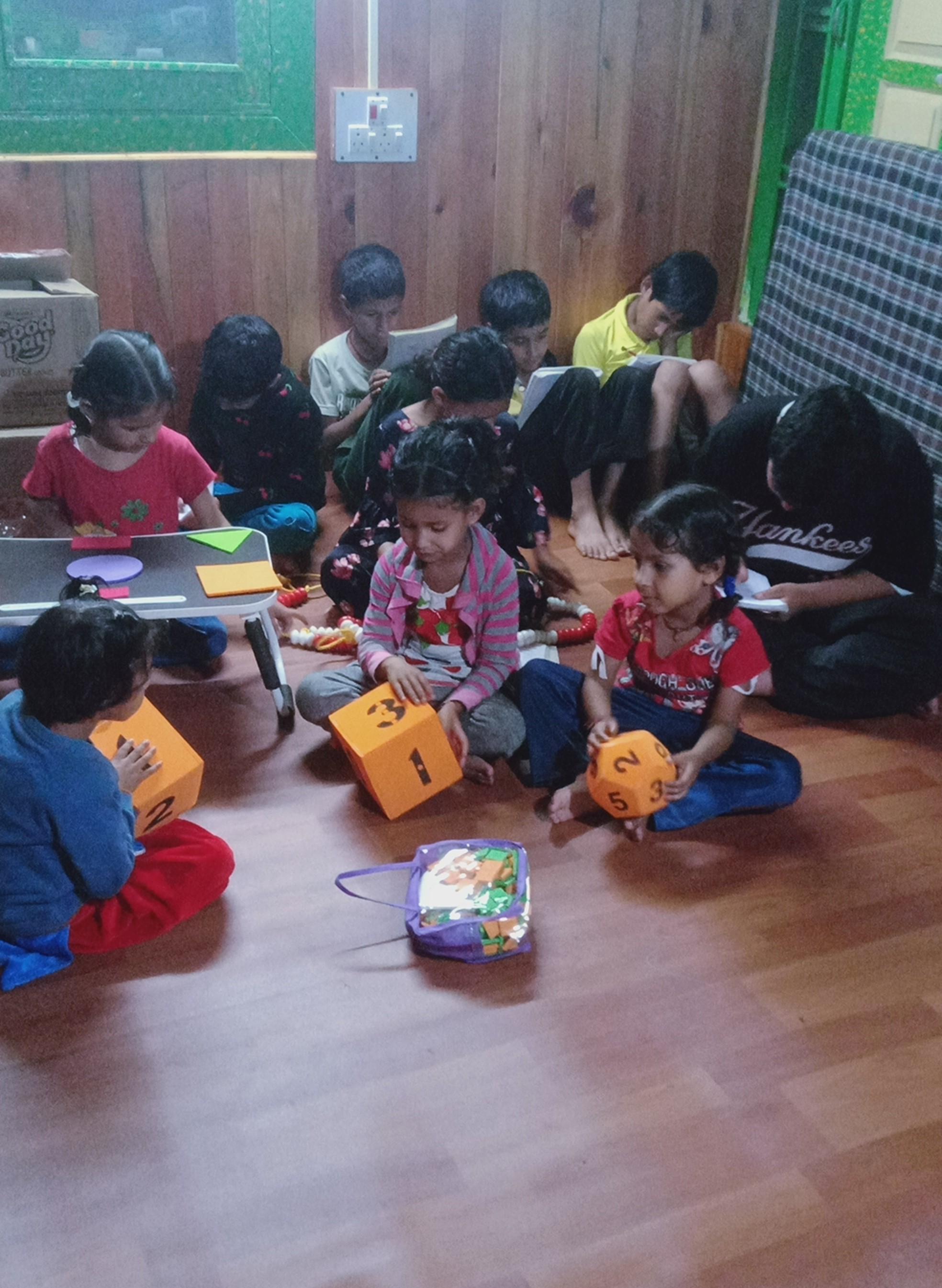 Children learning numbers using Jodo Gyan blocks